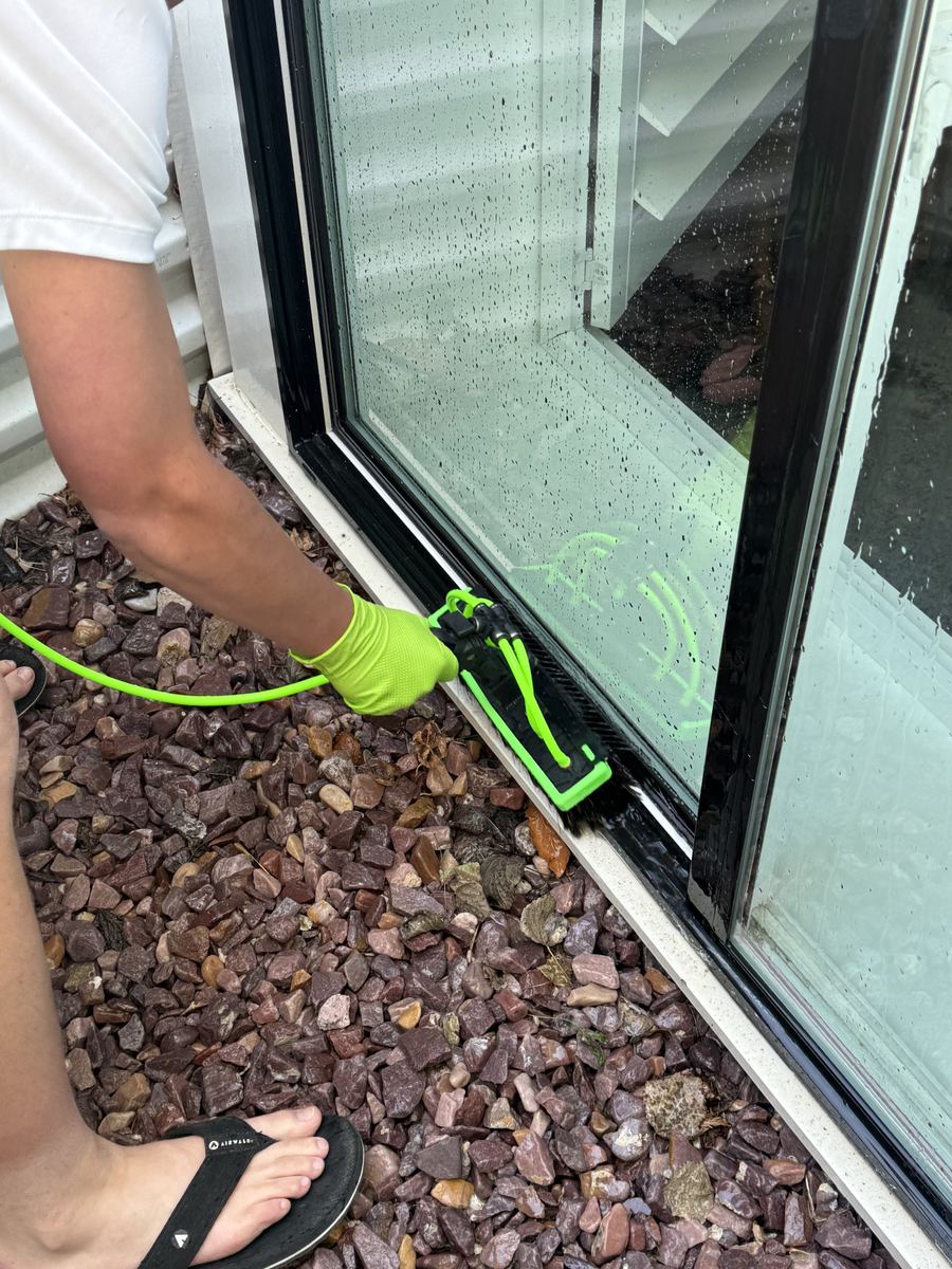 Detail work on a ground-level window with water-fed brush